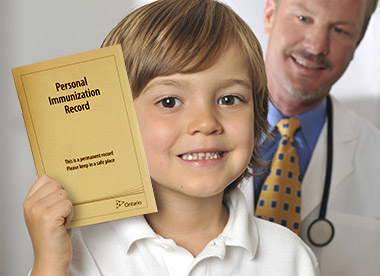 Photo of boy holding immunization record